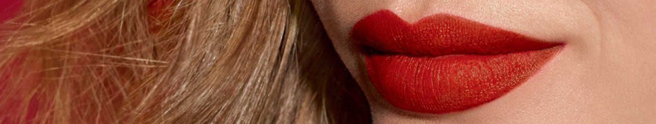 Maybelline Lipstick products illustrative banner image - Close up of woman wearing bright lipstick